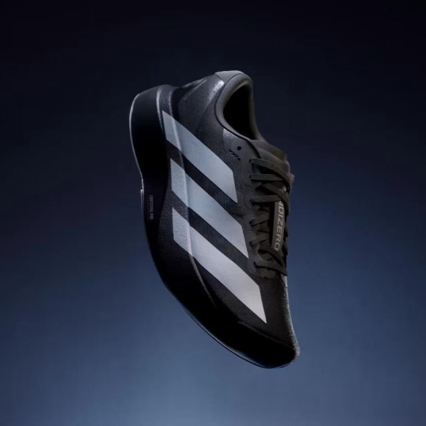 Black and white sneaker with three stripes on a dark blue background