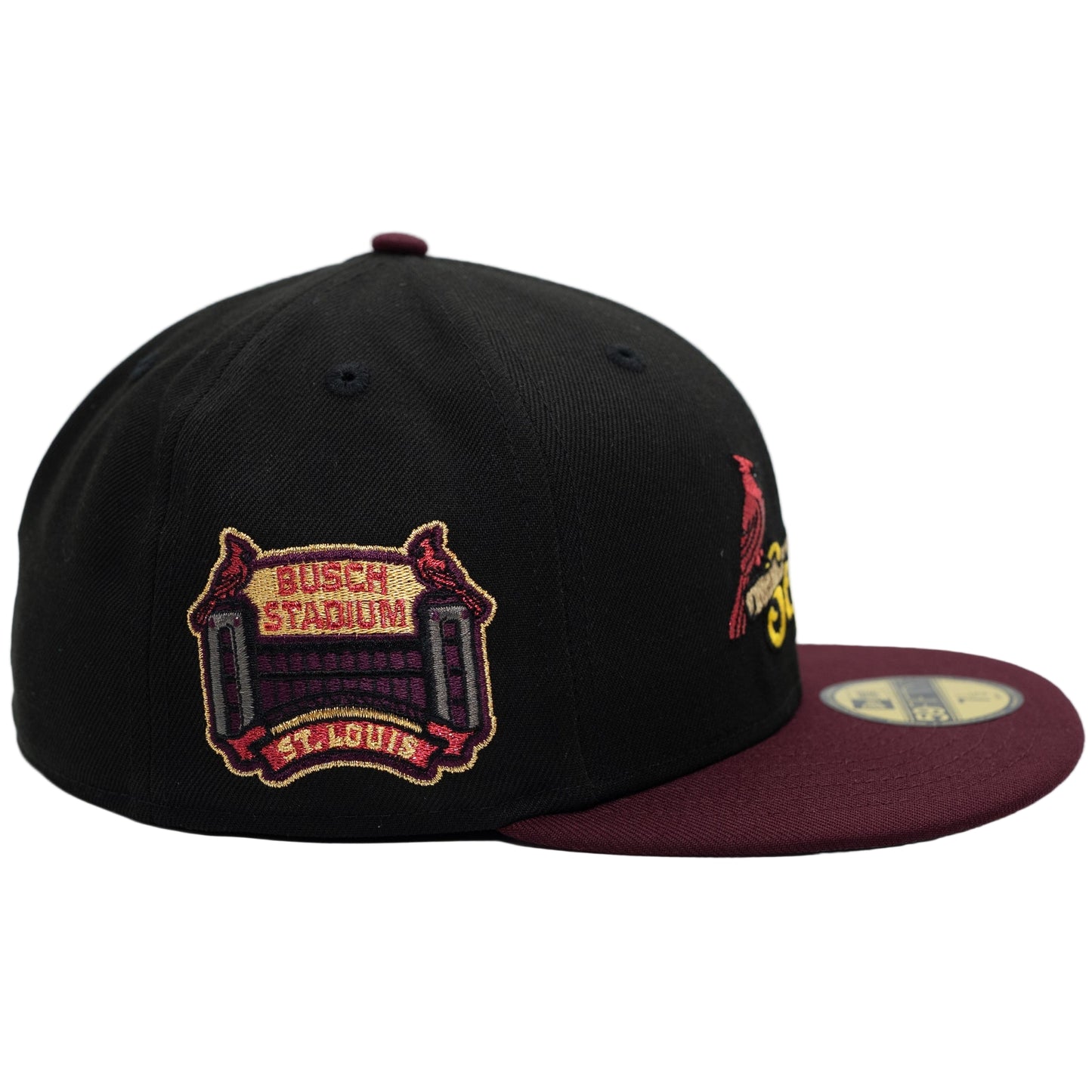 Black and maroon baseball cap with embroidered design on a white background
