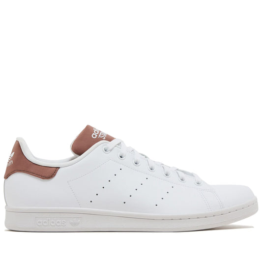 White Adidas sneaker with brown accents on a white background