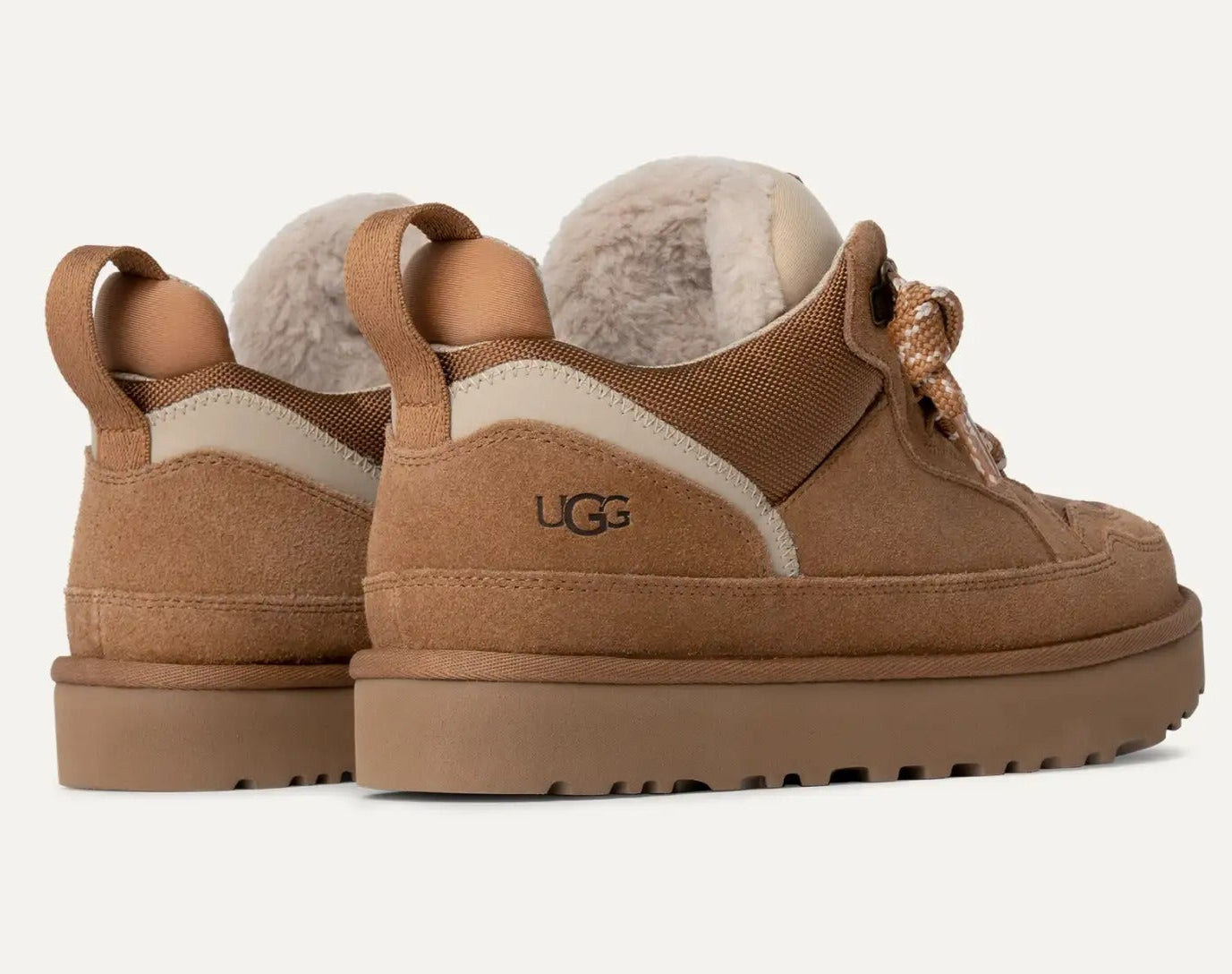 Brown UGG boots with sheepskin lining on a white background