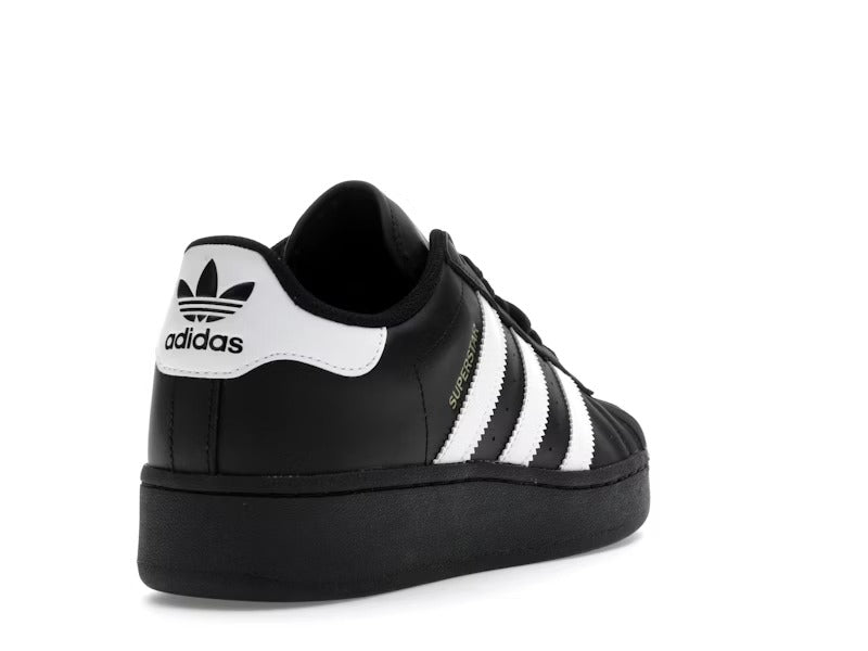 Black Adidas sneaker with white stripes on a white background