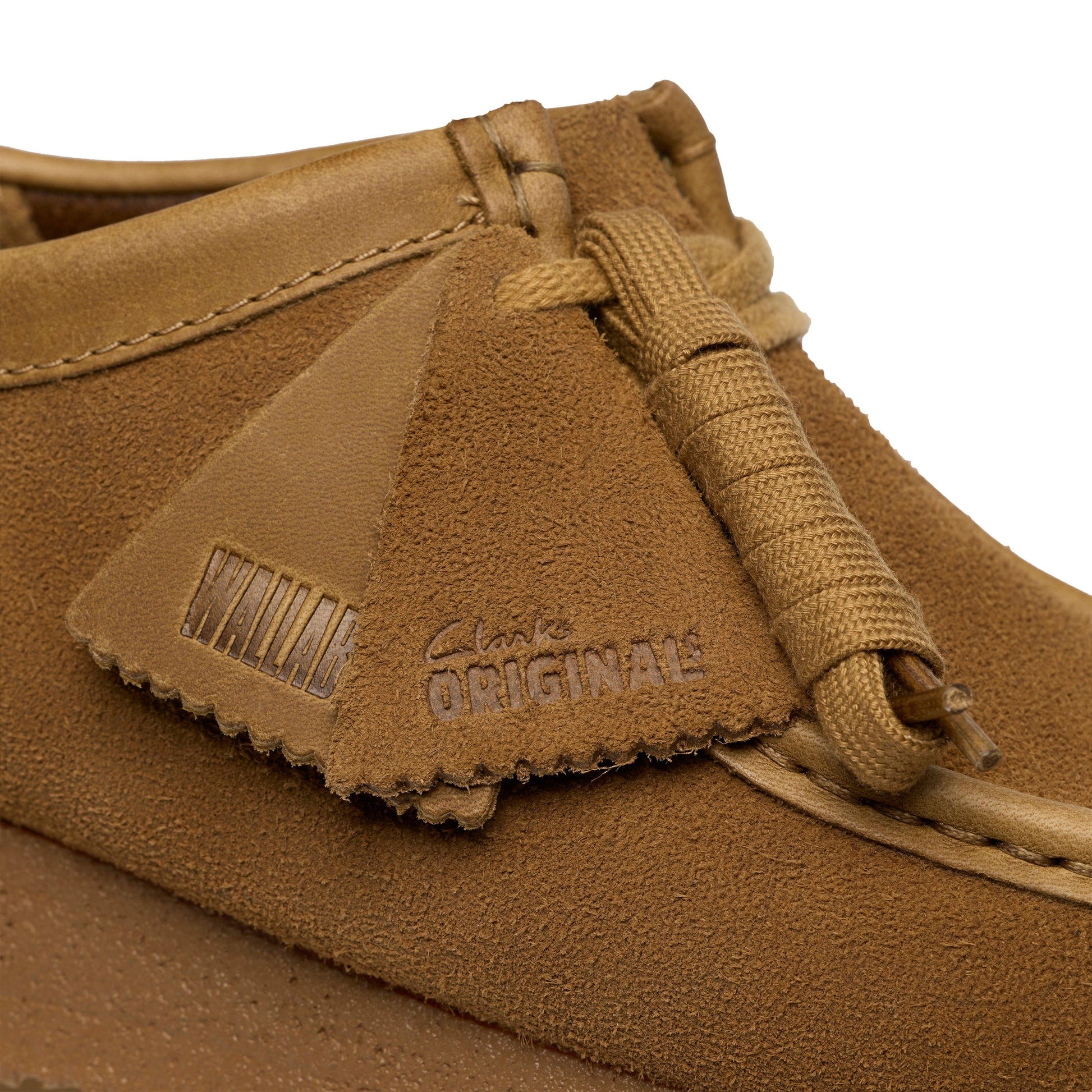 Brown suede shoe with 'Clarks Originals' branding on a white background