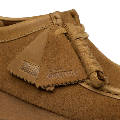 Brown suede shoe with 'Clarks Originals' branding on a white background