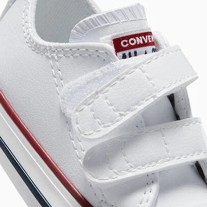 White Converse shoe with red and blue accents on a white background