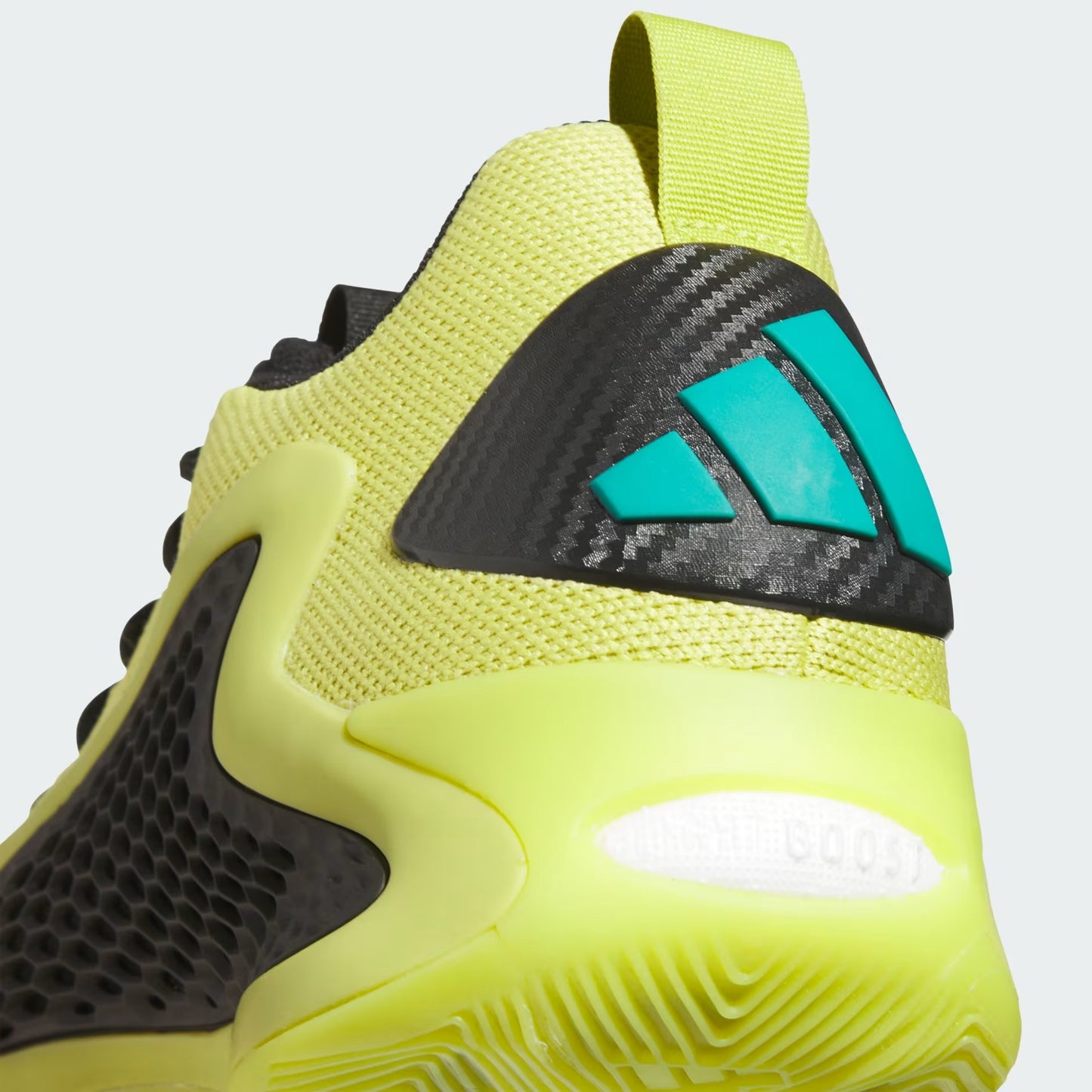 Yellow and black athletic shoe with a brand logo on a light gray background