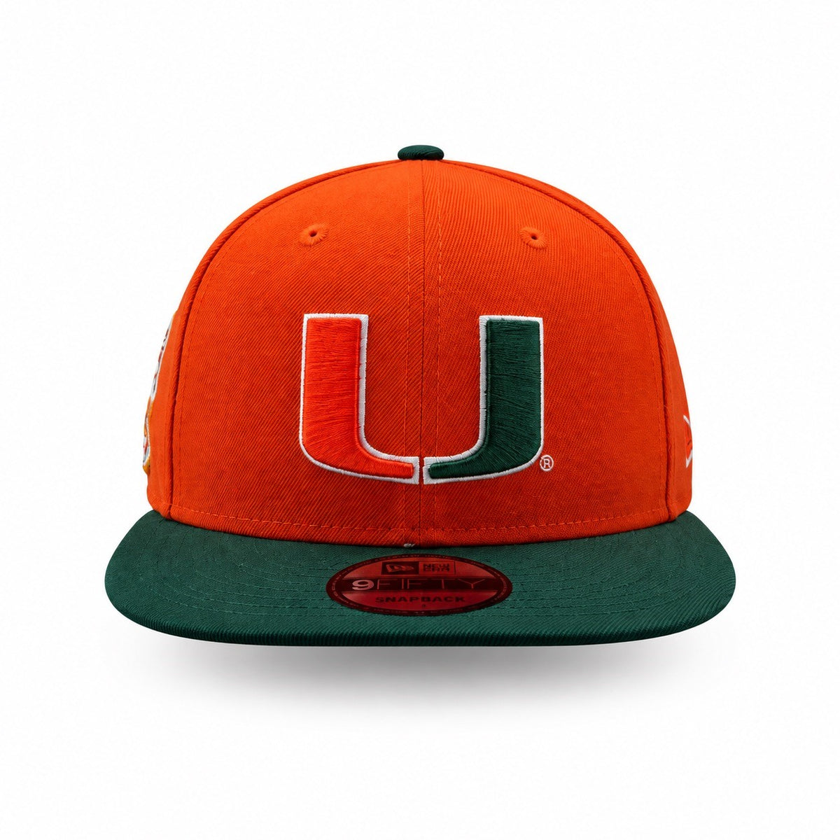 An orange and green Miami Hurricanes New Era 9FIFTY fitted cap with a large embroidered 'U' logo on the front, set against a plain white background.