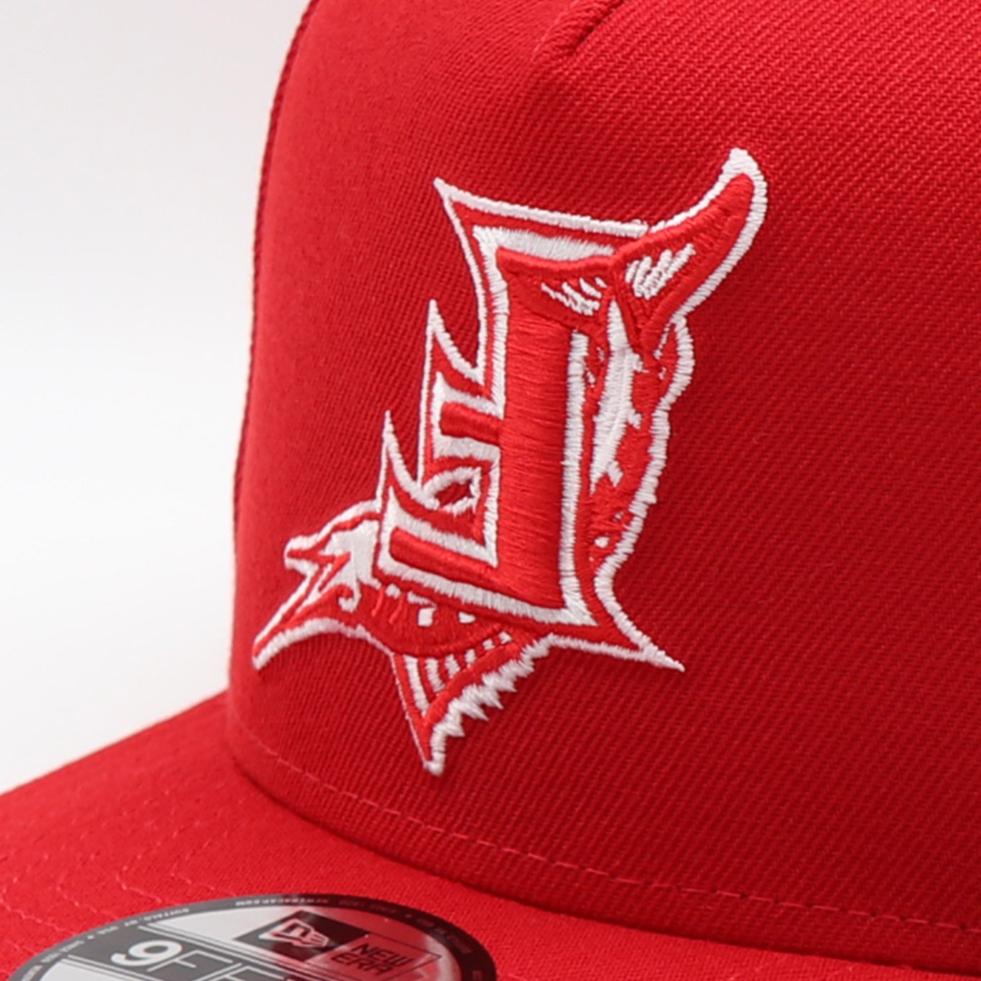 Red cap with a white Florida_Marlins logo fliped upside down on red cap