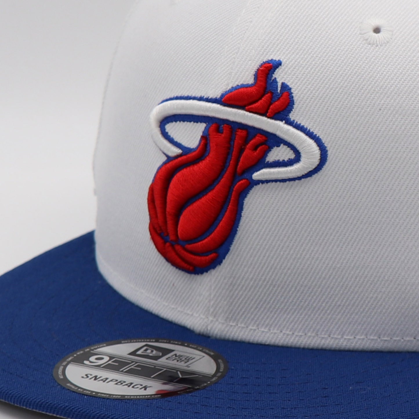 White and blue cap with red and blue logo, featuring New Era branding.