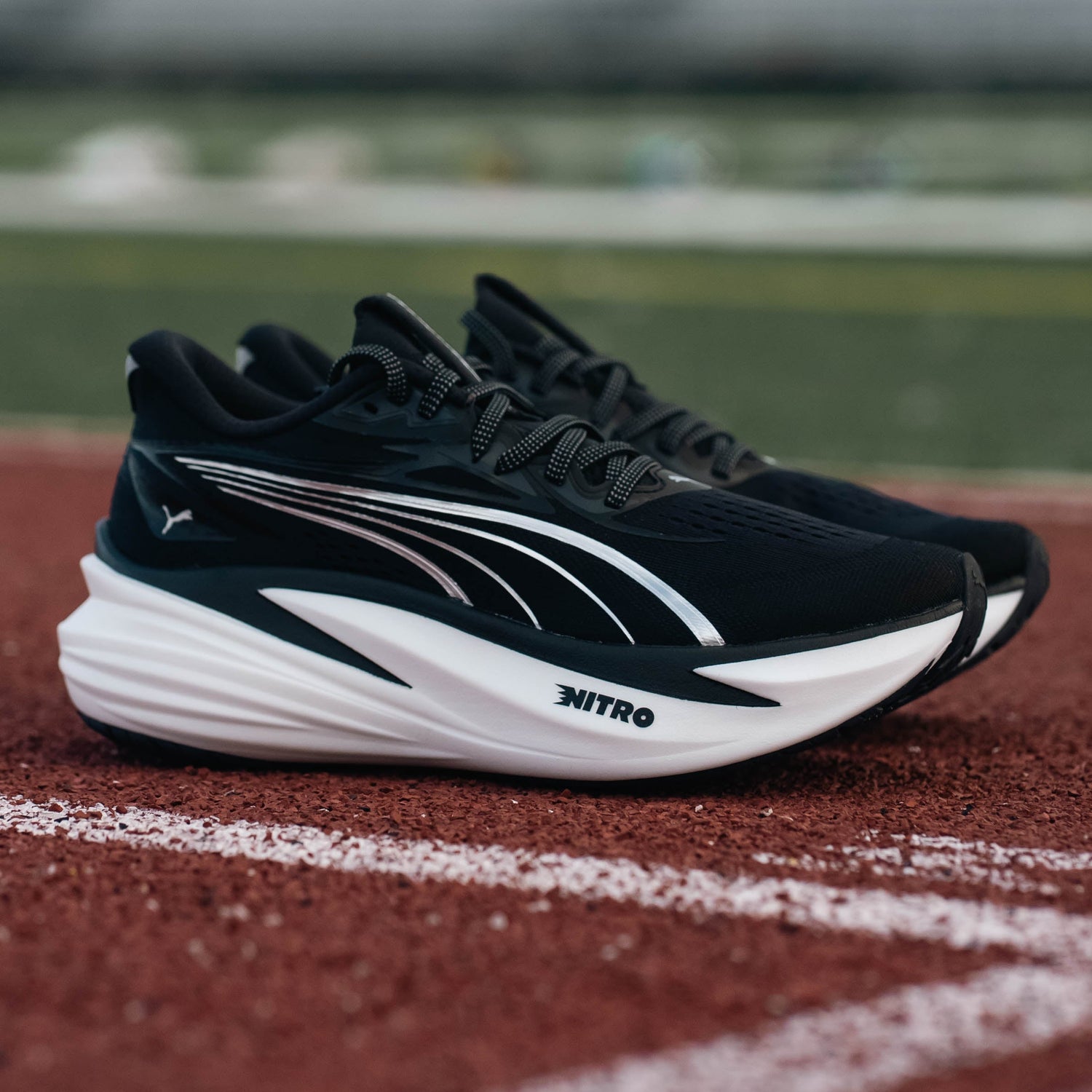 Black and white running shoes on a track