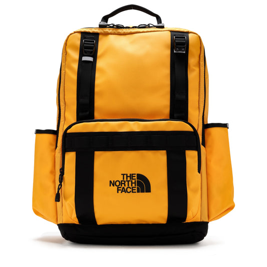 The North Face Base Camp Daypack in Summit Gold and Black combines rugged durability with practical design, ideal for daily use and outdoor adventures. Crafted from water-resistant materials, it protects your essentials in varying conditions. The spacious main compartment and multiple pockets offer organized storage, while padded shoulder straps ensure comfort during extended wear. Its reinforced base enhances longevity, making this daypack a reliable companion for both urban environments and trail excursio