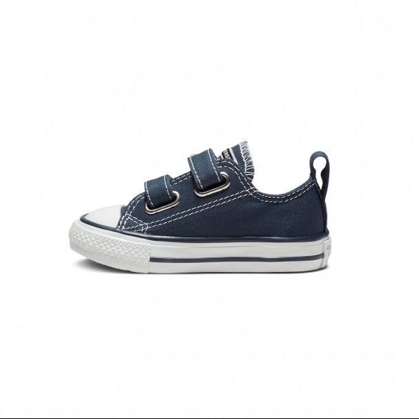 A single toddler's low-top canvas sneaker with two hook-and-loop straps, a black canvas upper, white rubber sole, and white contrast stitching, shown from a side profile on a white background.