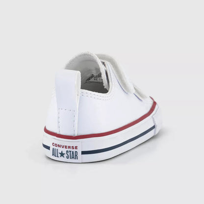 A white Converse All-Star low-top sneaker shown from a rear three-quarter angle on a light gray background.