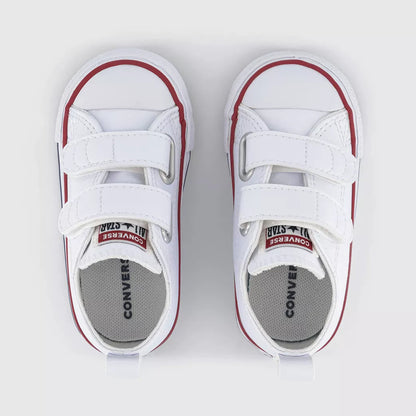 A pair of white Converse Kids platform sneakers with hook-and-loop straps, featuring red piping and a gray Converse Kids insole, shown from a top-down view on a light gray background.