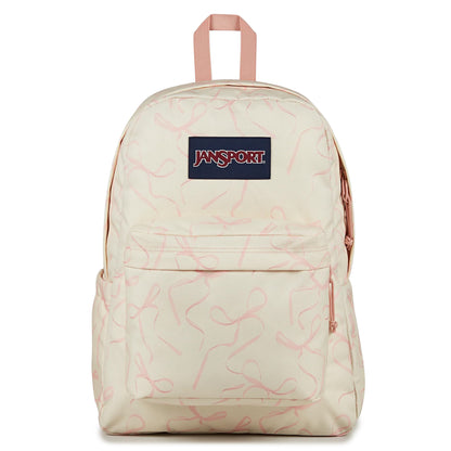 A JanSport backpack in cream with a light pink abstract scribble pattern, featuring a navy blue front patch with red and white JanSport branding.